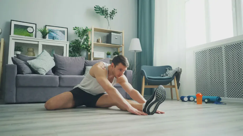 Compact dumbbells arranged on a workout mat in a small apartment living space