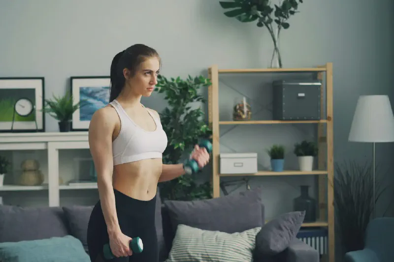 A compact treadmill positioned in a small, tidy home workout area