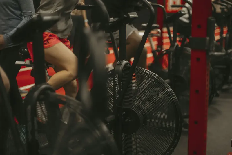 A home exercise-bike setup showing the differing shapes of upright, recumbent and folding exercise bikes.