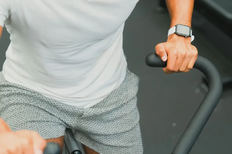 A compact exercise bike positioned in a bright, tidy small home workout area